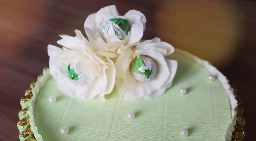 Торт из конфет: Крышку сверху декорируем цветами и бусинами.