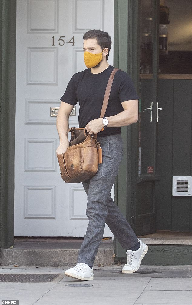 Stop off: He nipped into a shop for something, donning a mustard face-mask to abide by the COVID-19 rules in force currently in stores