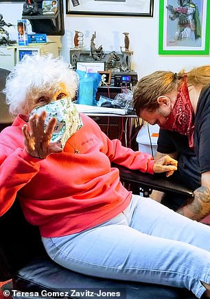 She got the tattoo on her left forearm by tattoo artist Ray Reasoner Jr. (right)