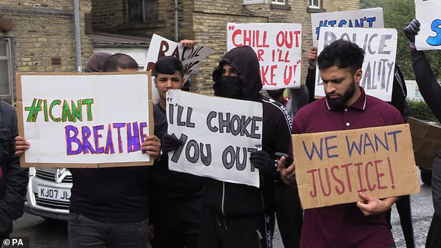 People with placards gathered for a demonstration outside Halifax police station on Wednesday afternoon