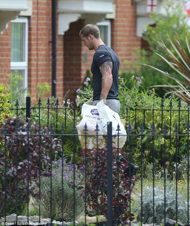 Doting dad: On Thursday, Dan Osborne was spotted running errands and buying gifts for Jacqueline Jossa and his newborn baby, Mia, in Kent, Canterbury