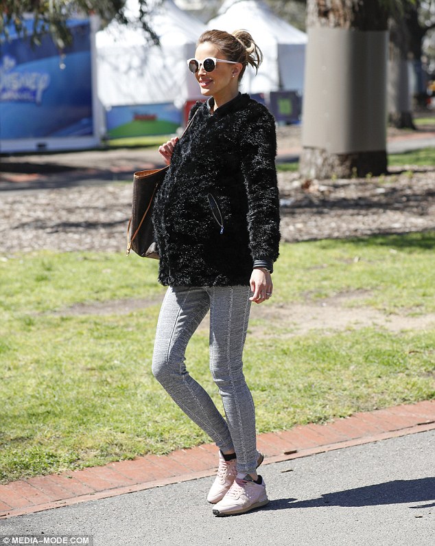 Babies on board! On Wednesday, Rebecca was seen going for a walk in Melbourne, hiding her ready-to-pop stomach underneath a fluffy black jumper