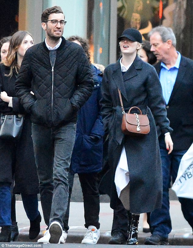 Walking in a winter wonderland: The Oscar-winning actress wrapped up against the winter chill in a charcoal grey FRAME coat, teamed with a white shirt dress and black PVC shoe boots
